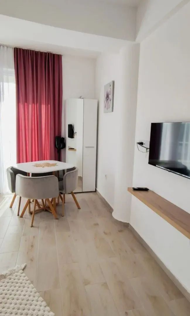 Living room with a dining table and TV.