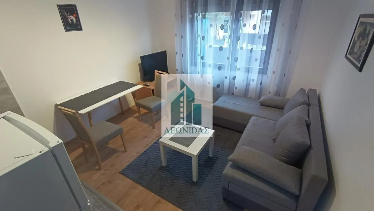 Living room with a sofa set, coffee table, and dining area.