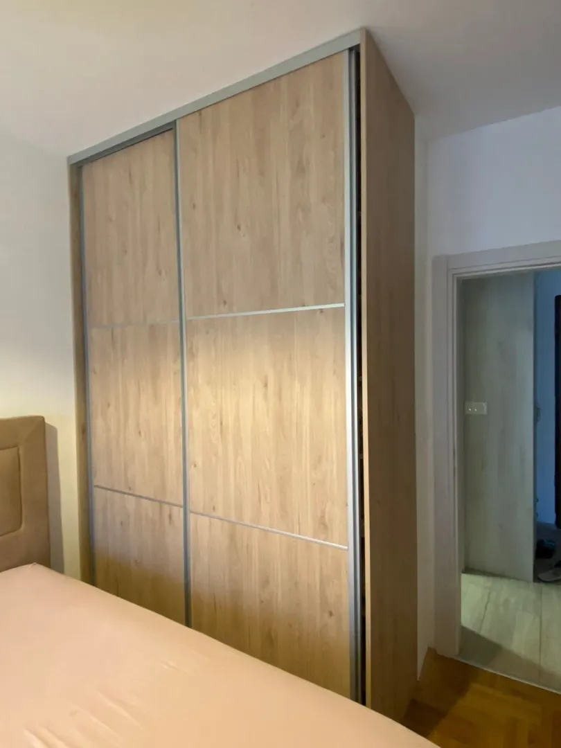 View of the bedroom with a built-in wardrobe and part of the bed.