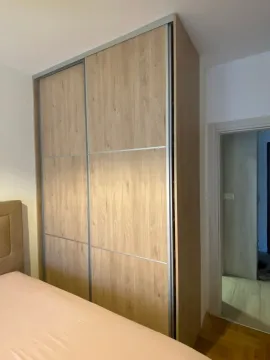 View of the bedroom with a built-in wardrobe and part of the bed. - image 8