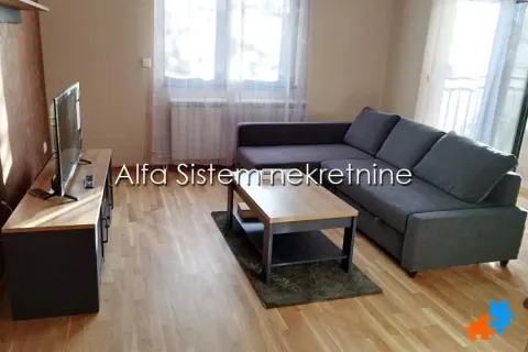 Living room with a sectional sofa, TV, and a wooden coffee table. - image 2