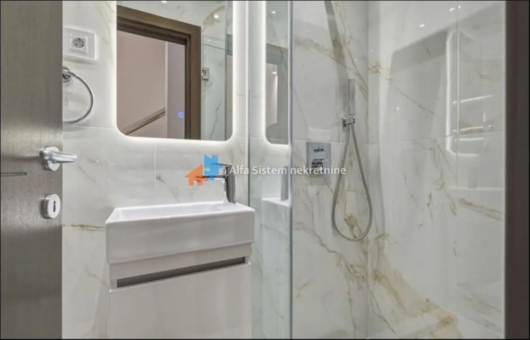 Modernly equipped bathroom with a shower cabin and a washbasin.
