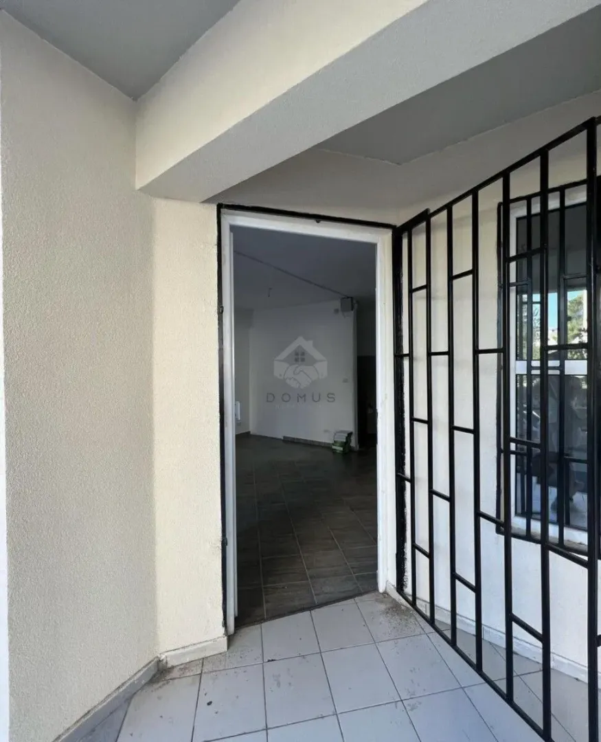 Entrance to a commercial space with protective grills on the window.