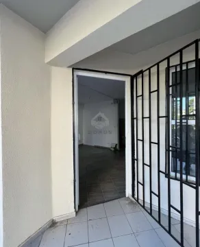 Entrance to a commercial space with protective grills on the window. - image 6
