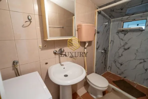 Smaller equipped bathroom with a sink, toilet, and shower cabin. - image 8