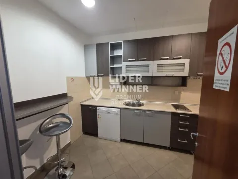 Kitchen with dark cabinetry and a breakfast bar with bar stools. - image 4