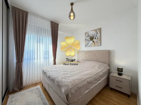 Furnished bedroom with a double bed, nightstand, and window with curtains. - image 14