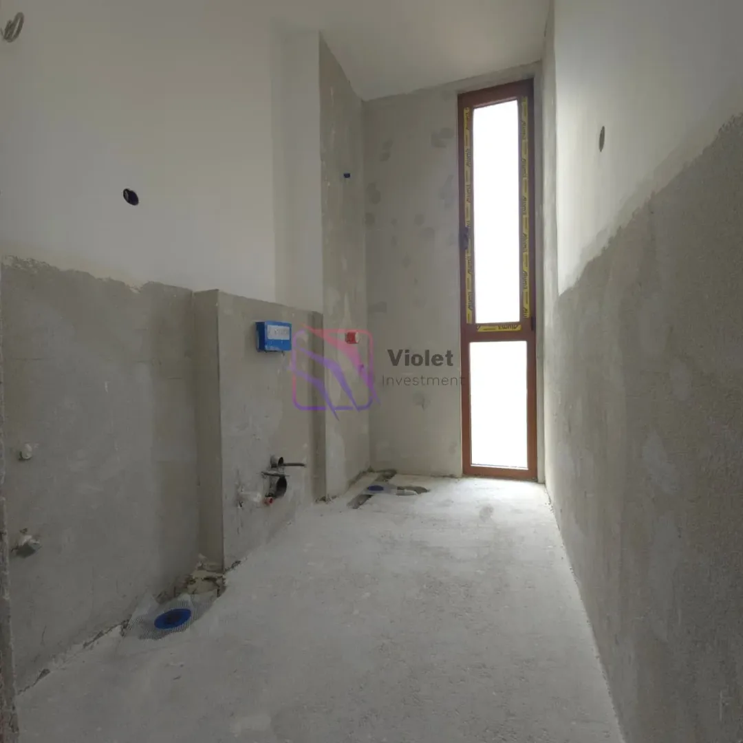 Unfinished room under construction with installations and a door.