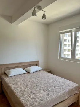 Bright bedroom with a double bed and a window. - image 5