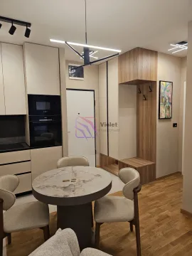 Modern kitchen with a dining table and built-in units. - image 7