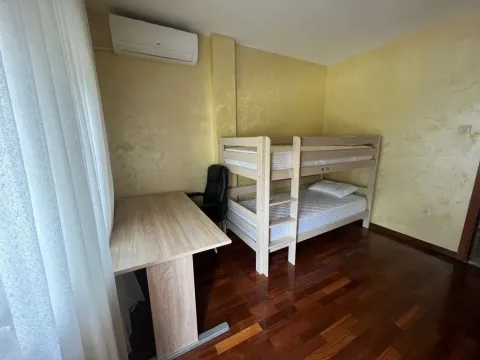 Children's bedroom with a bunk bed and a desk. - image 3