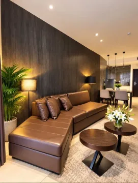 Living room with a brown leather sofa and a dark wood wall panel. - image 5