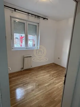 Empty room with hardwood floors and a window. - image 4