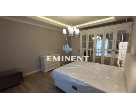 Spacious bedroom with a large double bed, white wardrobe, and chest of drawers. - image 11