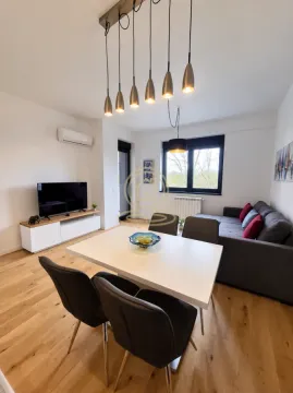 Living room with dining area, sofa and TV. - image 2