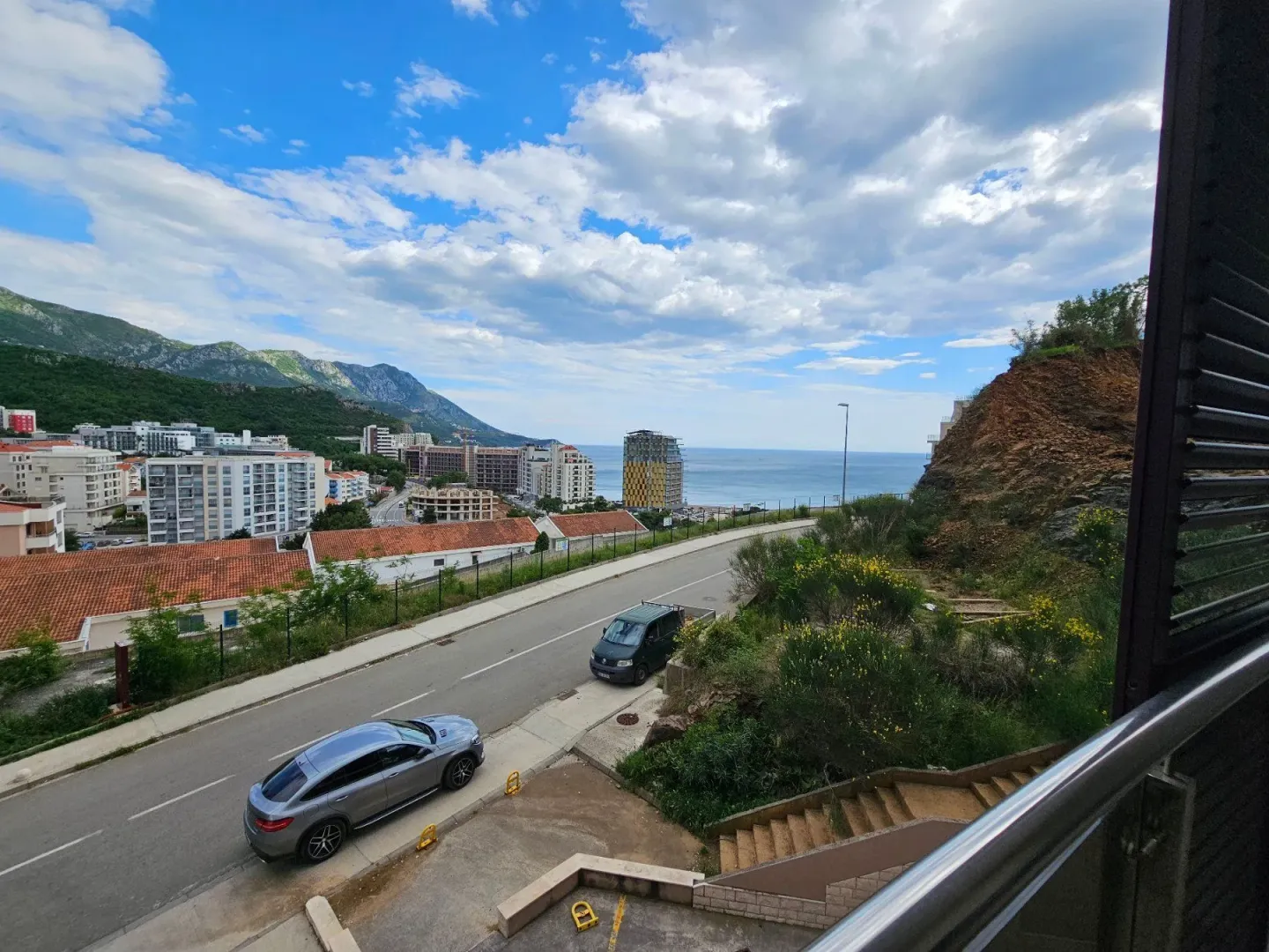 View of the city, street and sea from the terrace.