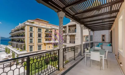 Spacious covered terrace with a dining table and seating furniture. - image 2