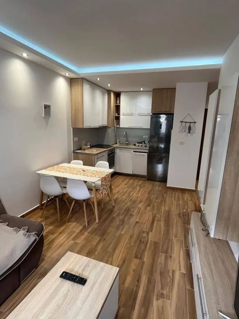 Modern kitchen with dining area and built-in appliances.