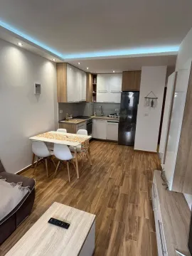 Modern kitchen with dining area and built-in appliances. - image 5