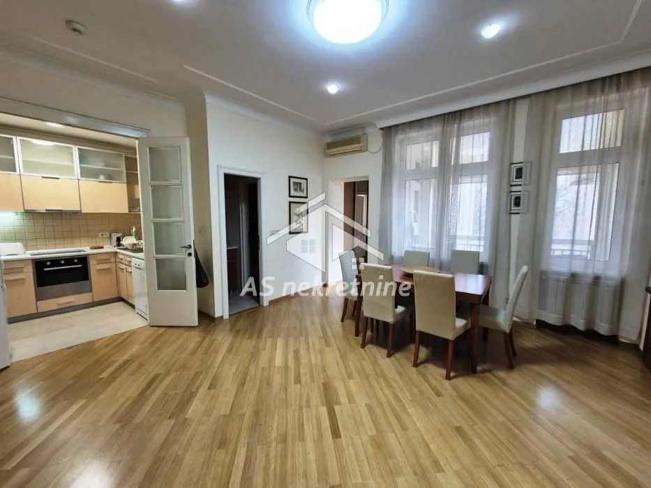 Living room with dining area and view of the kitchen.