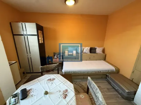 Furnished bedroom with a bed, wardrobe, and table. - image 3