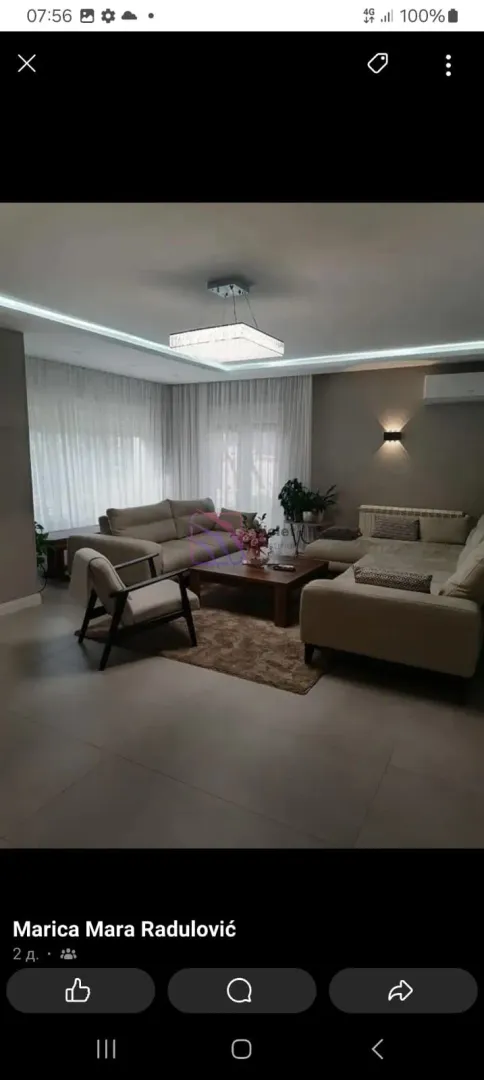 Spacious living room with a sofa set and modern lighting.