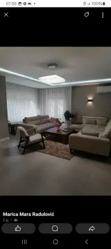 Spacious living room with a sofa set and modern lighting. - image 9