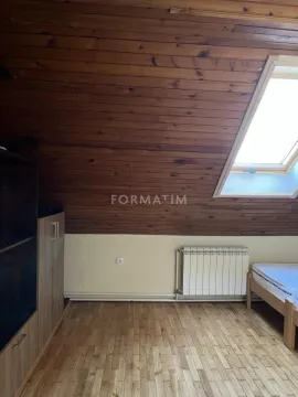 Attic room with wooden ceiling and skylight. - image 10