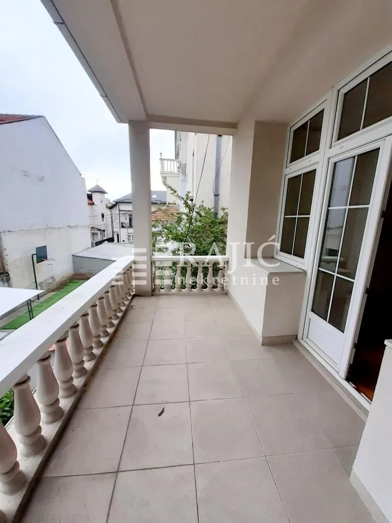 Spacious covered terrace overlooking surrounding buildings and courtyard.