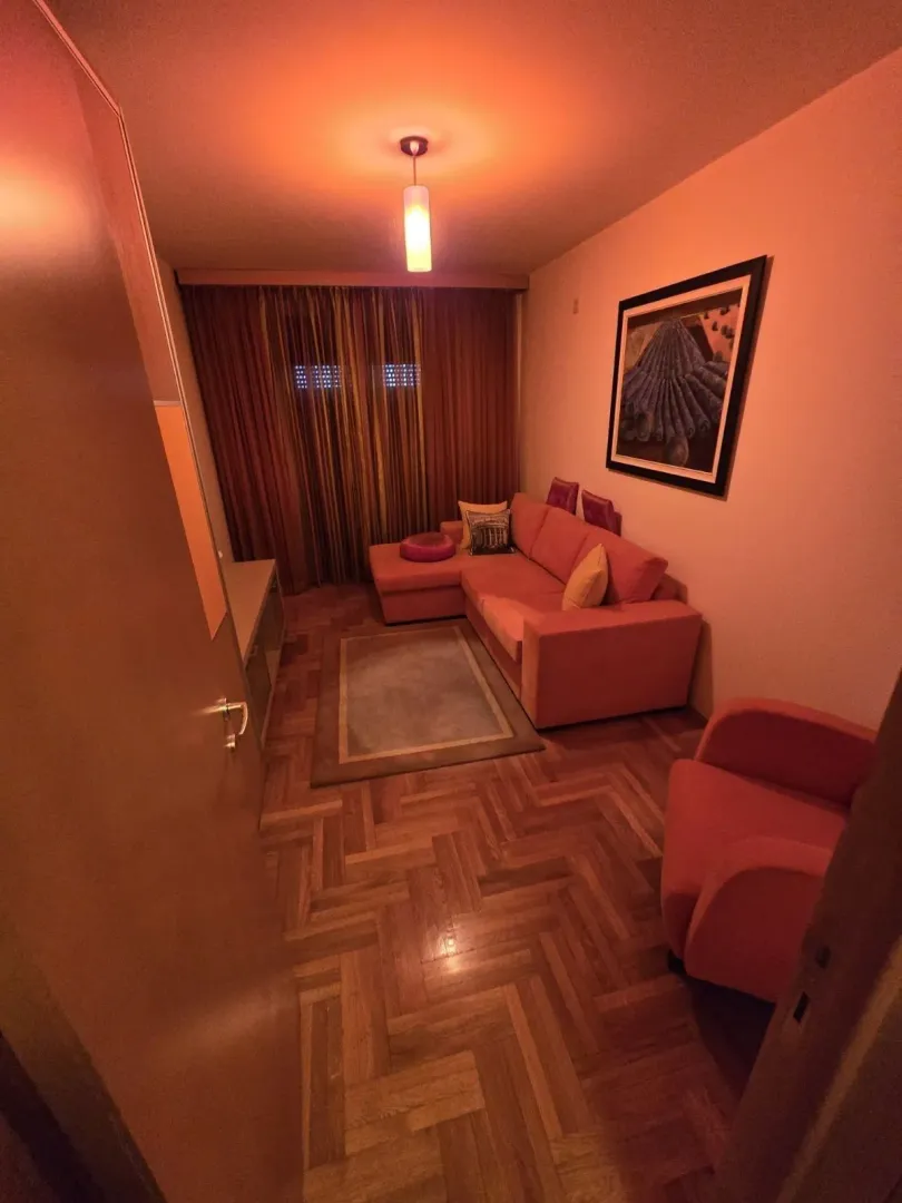 Living room with a corner sofa and warm lighting.