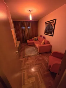 Living room with a corner sofa and warm lighting. - image 7