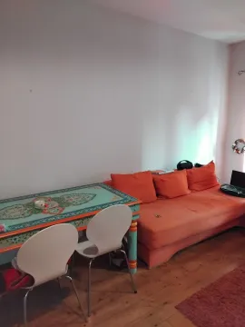 Dnevna soba sa narandžastom garniturom i trpezarijskim stolom. - image 2