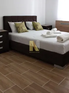 Furnished bedroom with a double bed and bedside tables. - image 9