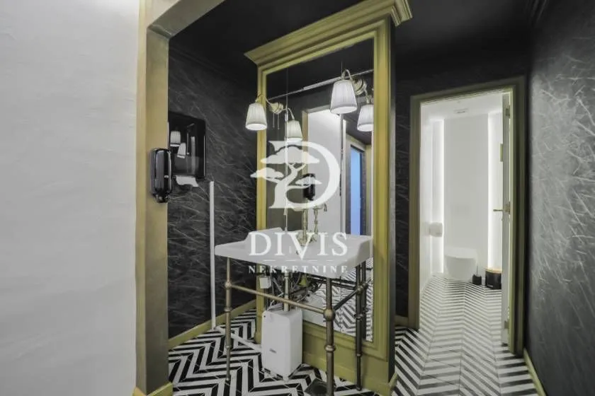 Modern bathroom with a sink and decorative tiles.