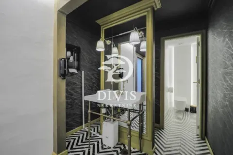 Modern bathroom with a sink and decorative tiles. - image 16