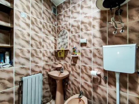 Smaller bathroom tiled with ceramic tiles featuring a sink, bidet and toilet. - image 14