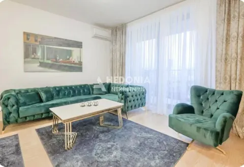Living room with a green sofa set, an armchair, and a white coffee table. - image 2