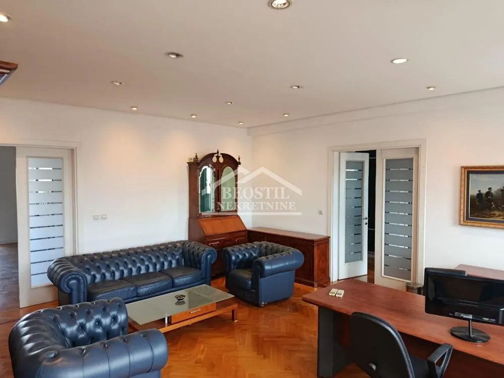 Spacious living room with a sofa set and a desk.