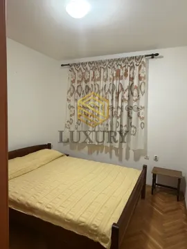 Spavaća soba sa bračnim krevetom i drvenim podom. - image 8