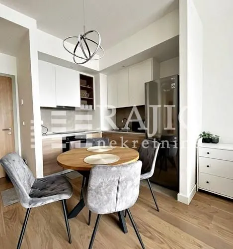 Modern kitchen with dining area and built-in appliances.