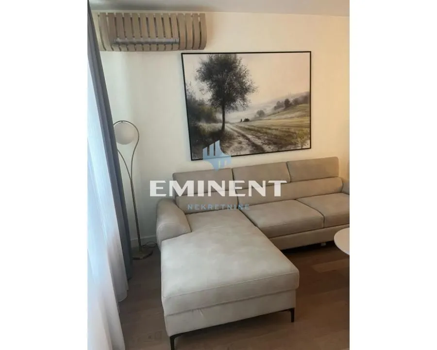 Corner sofa in the living room with an artwork on the wall.