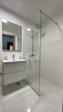 Modernly equipped bathroom with a washbasin and a walk-in shower with a glass partition. - image 7