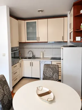 Kitchen with a dining table and built-in units. - image 4