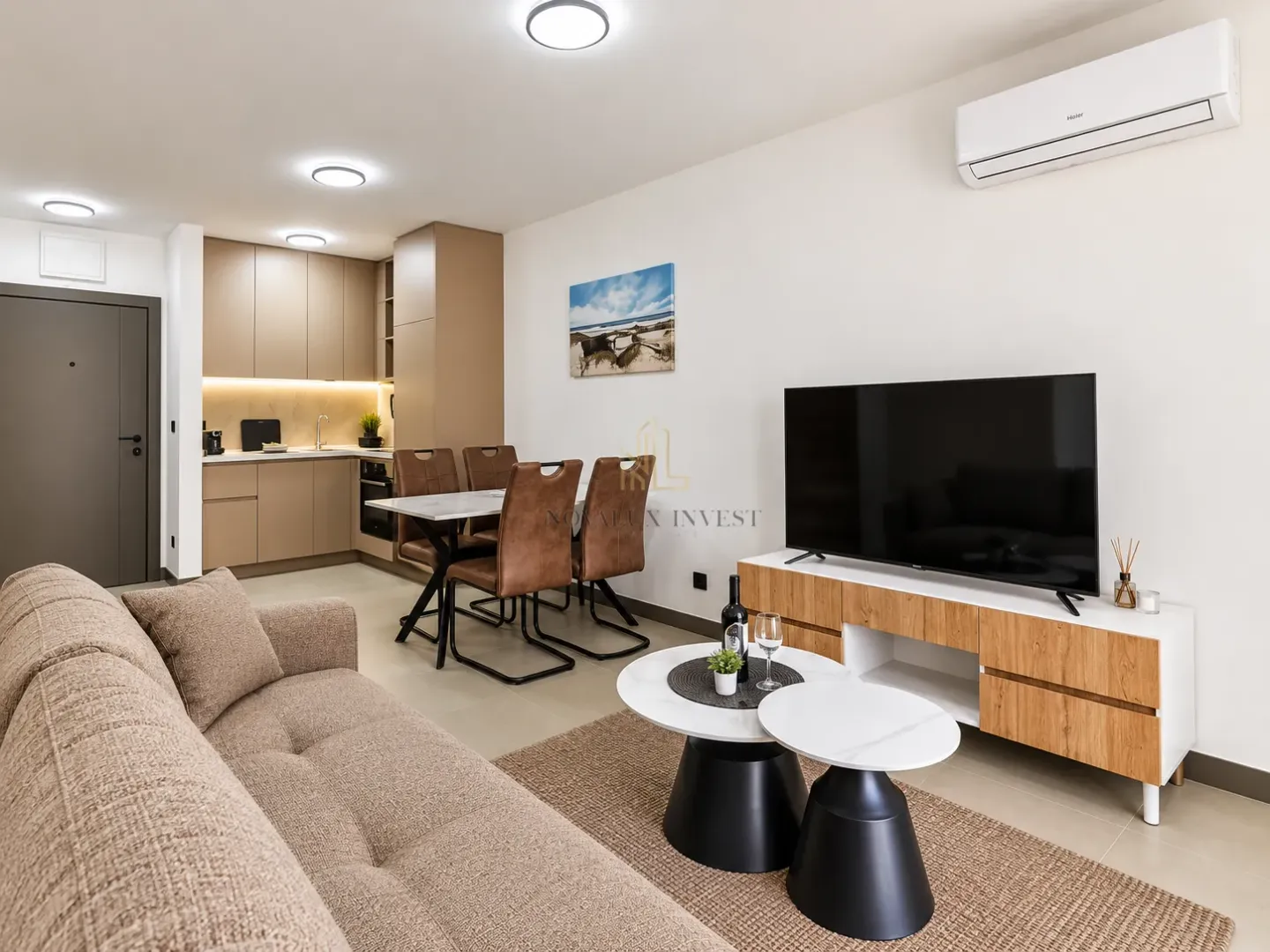 Living room with dining area and kitchen in an open space layout.