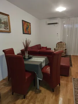 Living room featuring a dining table and red leather furniture. - image 11