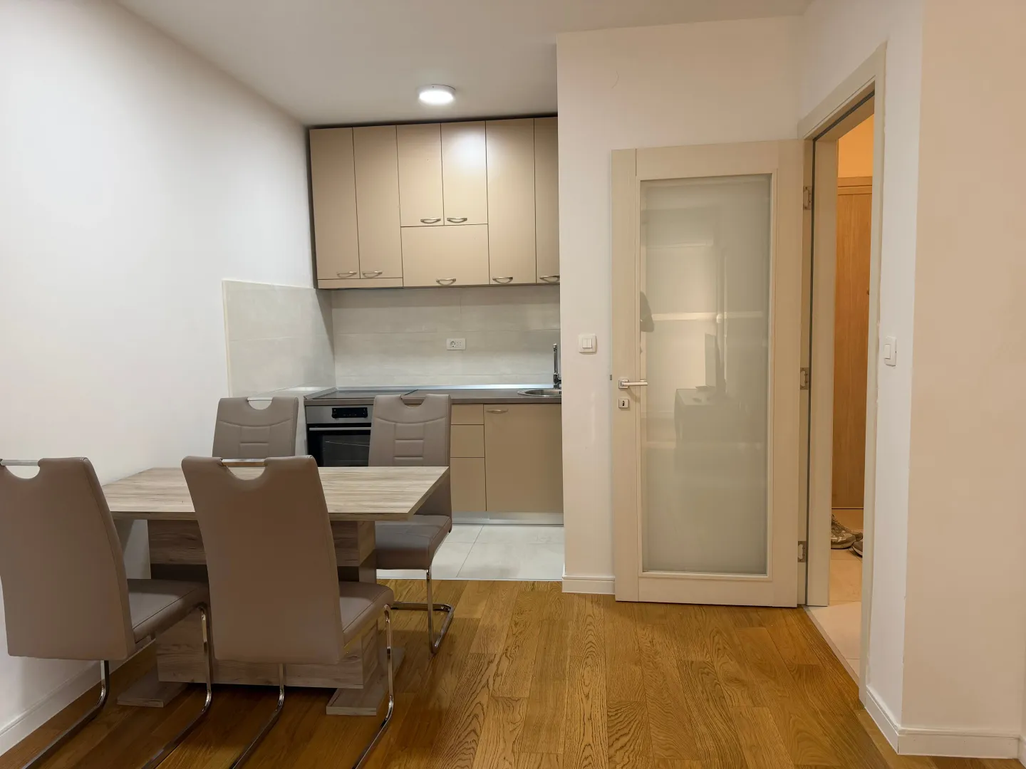 Dining area with a table and chairs overlooking the kitchen.