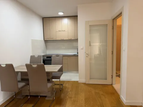 Dining area with a table and chairs overlooking the kitchen. - image 3