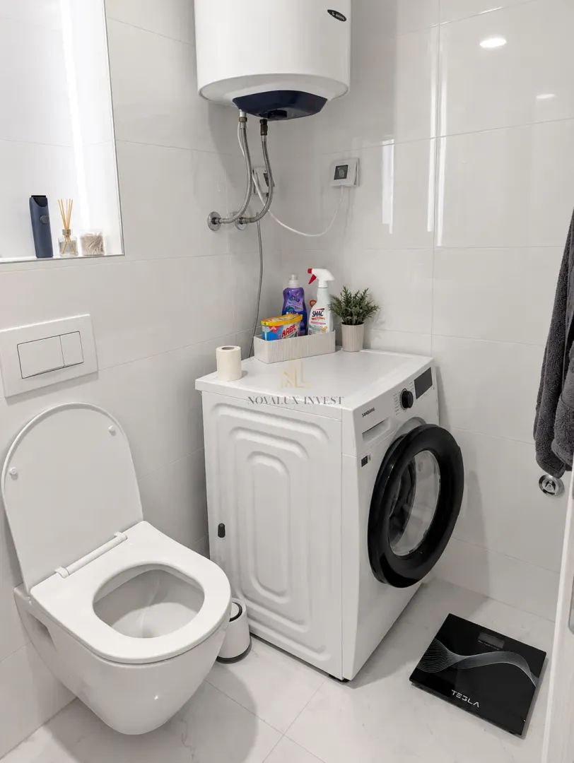 Bathroom with toilet and washing machine.