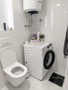 Bathroom with toilet and washing machine. - image 5