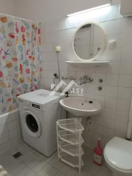 Kupatilo opremljeno sanitarijama, mašinom za veš i tuš kabinom sa zavesom. - image 7